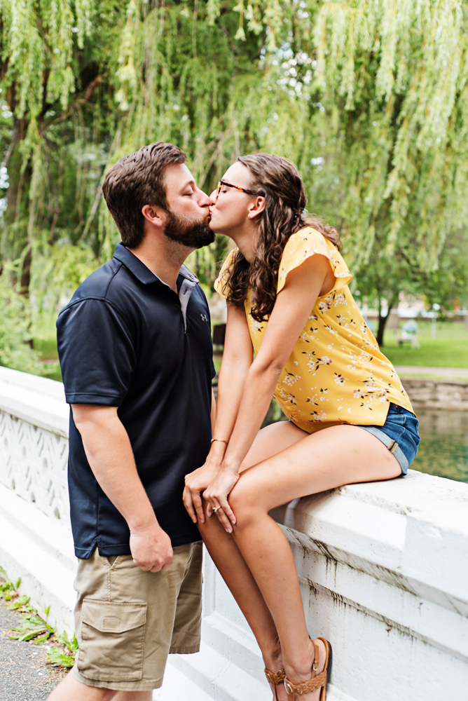 Engagement couple sitting on a bridge