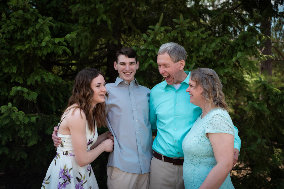 family of four laughing