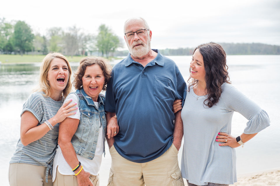 family at lake laughing