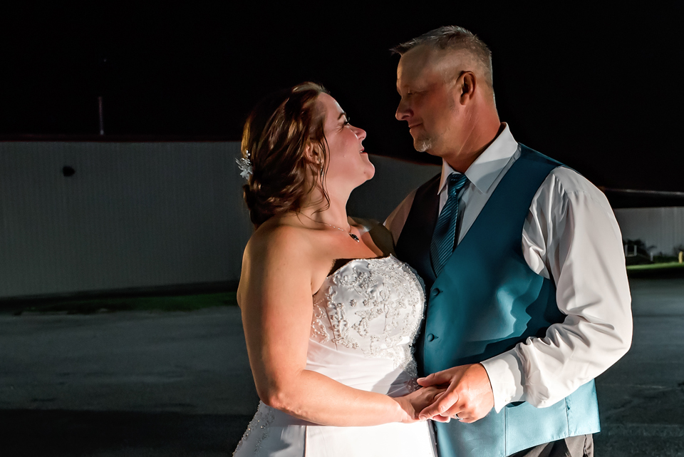Close-up of Bride and Groom looking at each other in the dark at Buck's Country Cookin in West Branch, MI