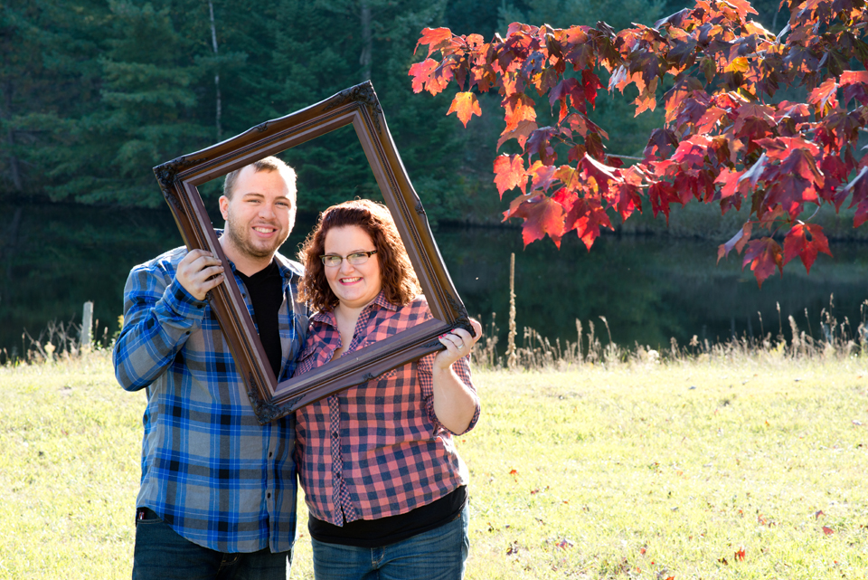 West Branch couple in frame with fall leaves