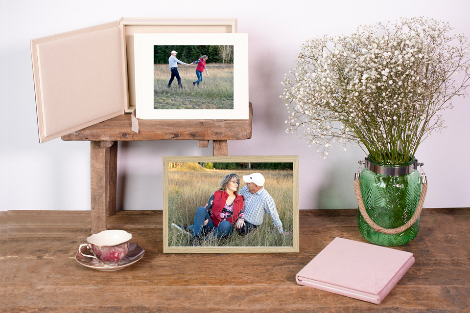 Image box with matted images and a desktop framed image setting on a table.
