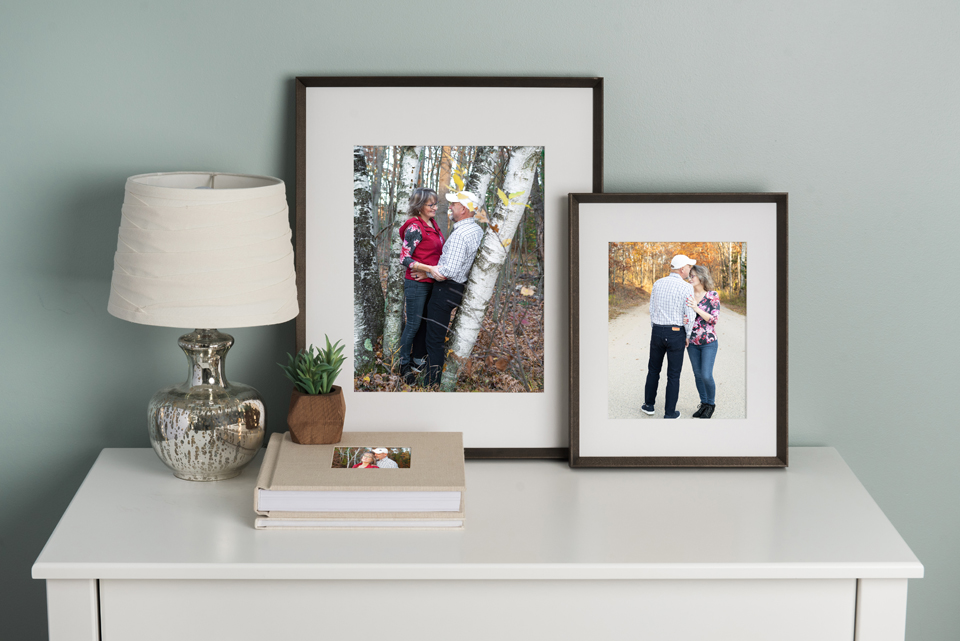 Desk top with Album, and matted, framed images on top.