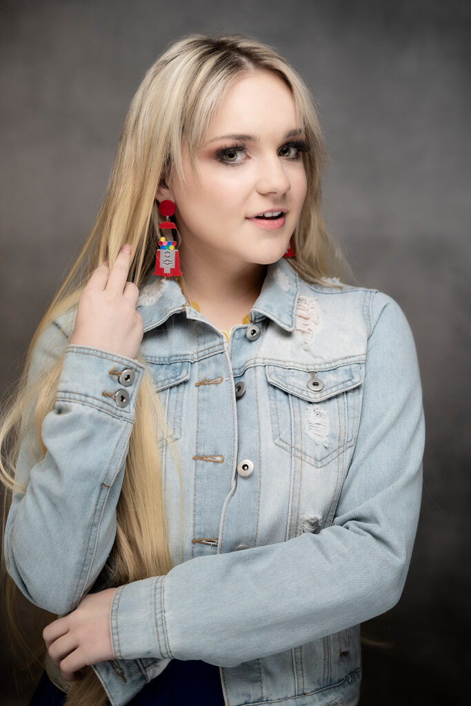 high school senior with earrings and long blonde hair