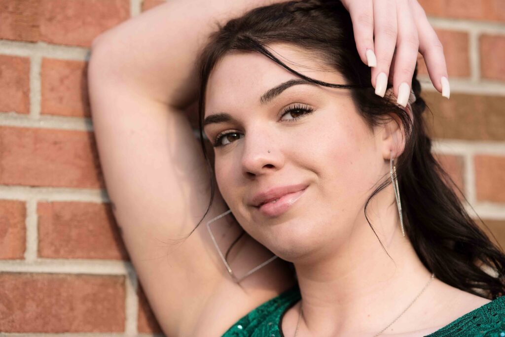 high school senior leaning on brick wall in Rose City, MI