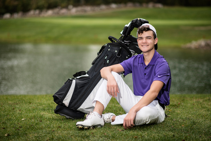 high school senior boy with golf bag