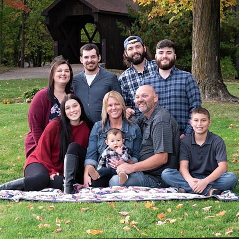 Family photo session at Iron's Park in West Branch, MI in red and blue.