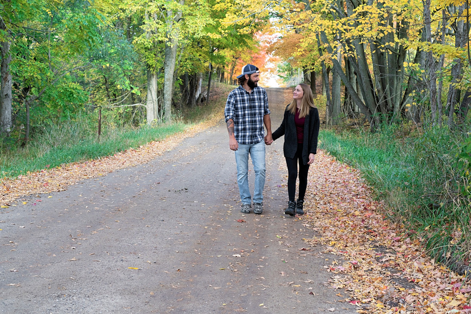 Couple walking down road in the fall colors