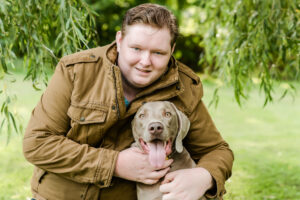 high school senior boy with his dog weimeraner