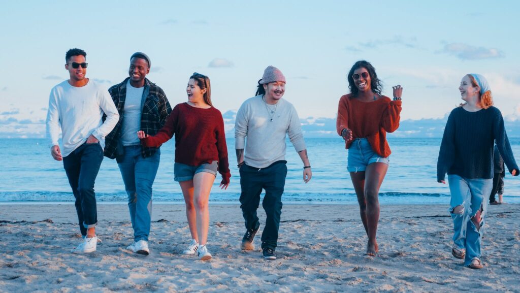 Group of Friends Walking on Beach Shore