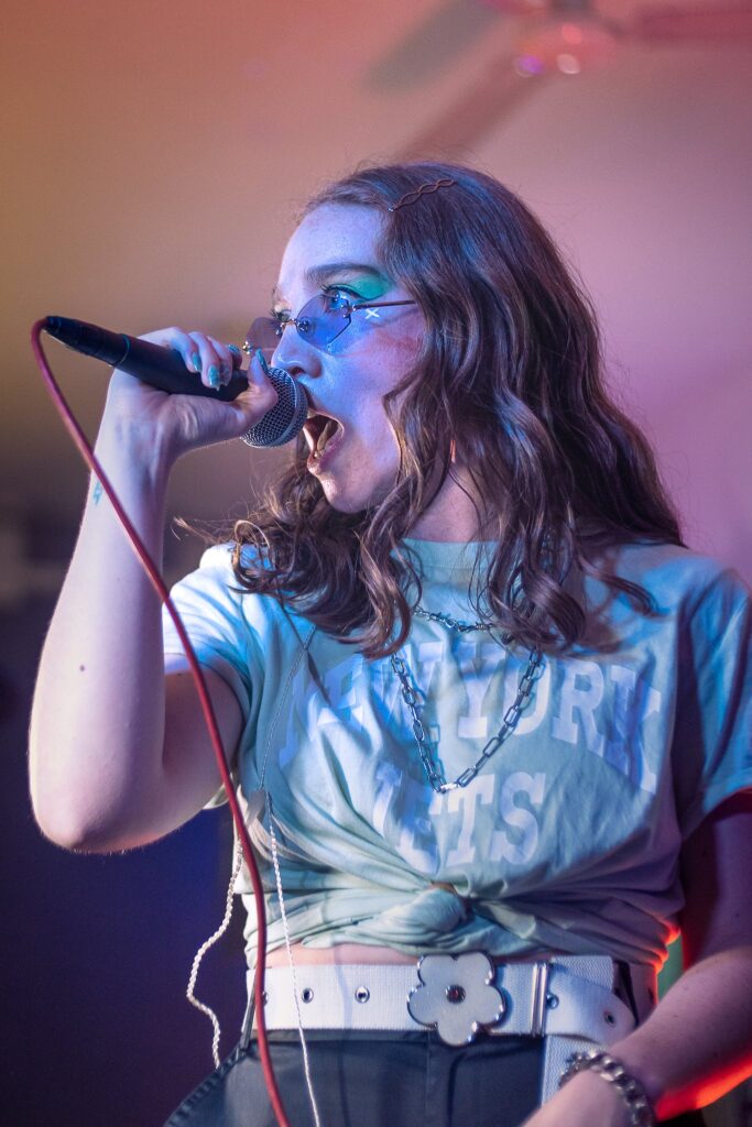 Woman in Sunglasses Singing in Microphone, karaoke party