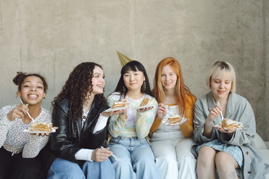 Women Sitting on Couch eating cake, graduation party ideas