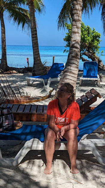 Sitting on a lawn chair on MOHO Caye, near Placencia, Belize