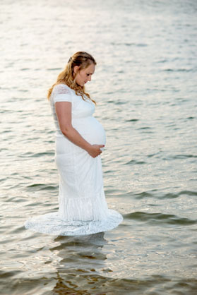 pregnant woman standing in a lake