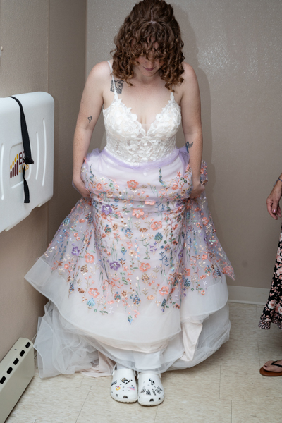 Bride showing off her wedding dress and shoes.
