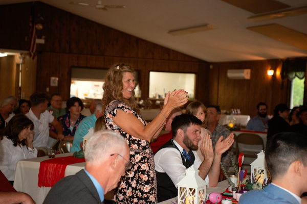 mother of the bride clapping after their first dance.