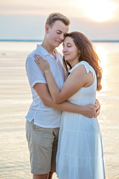Couple in water at sunset at East Tawas State Park