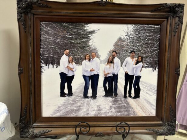 framed image of a family standing in the snow