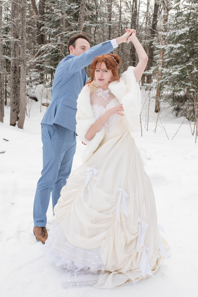 Bride and Groom twirl dance in snow