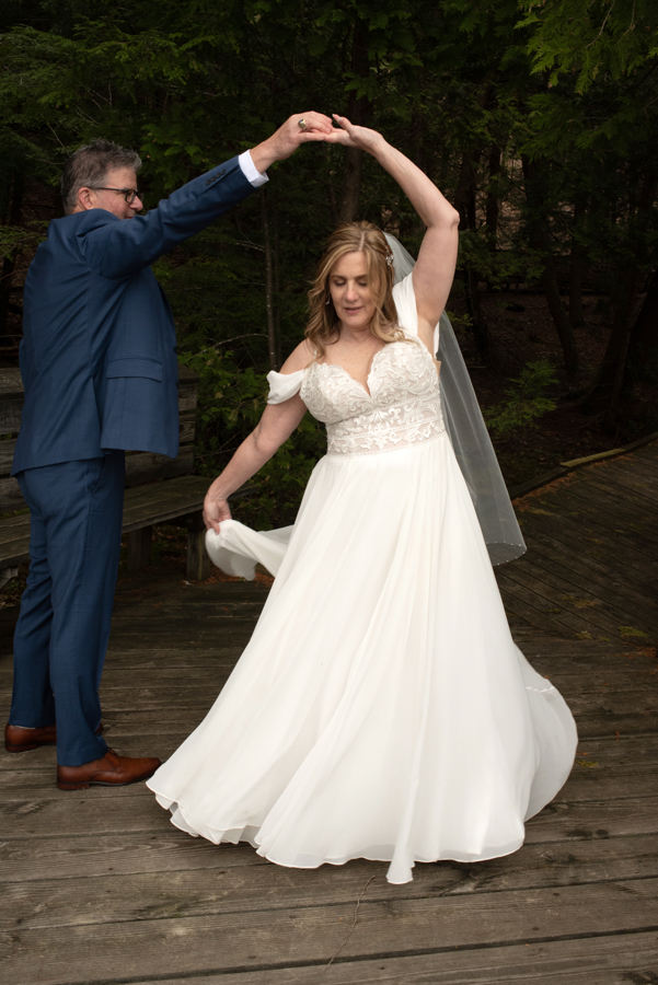 Groom twirling bride