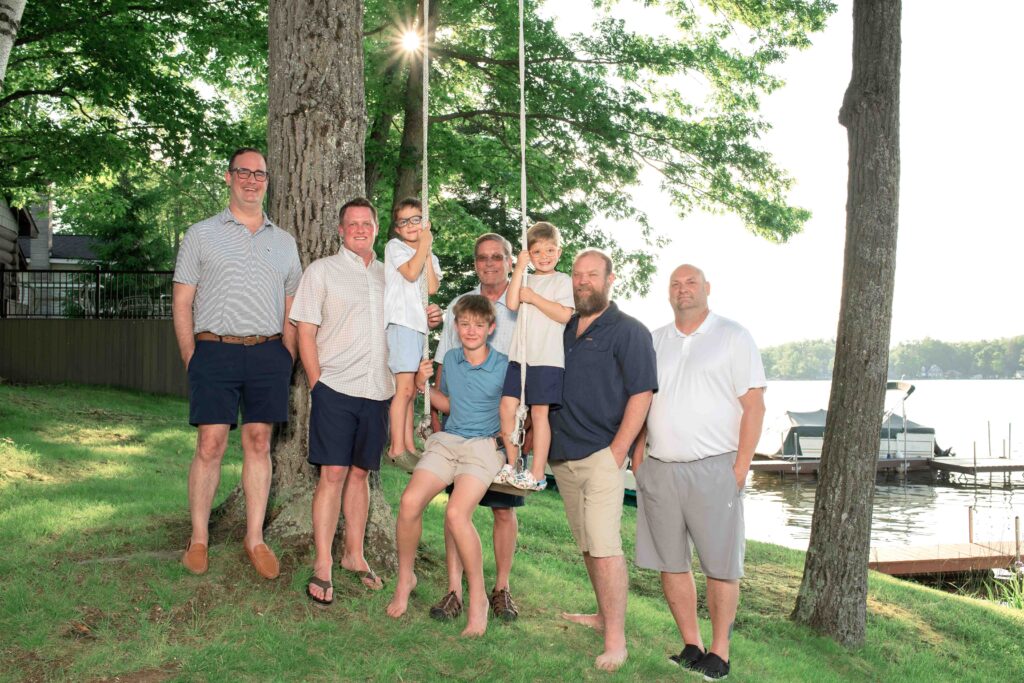 Family men around a swing at the lake