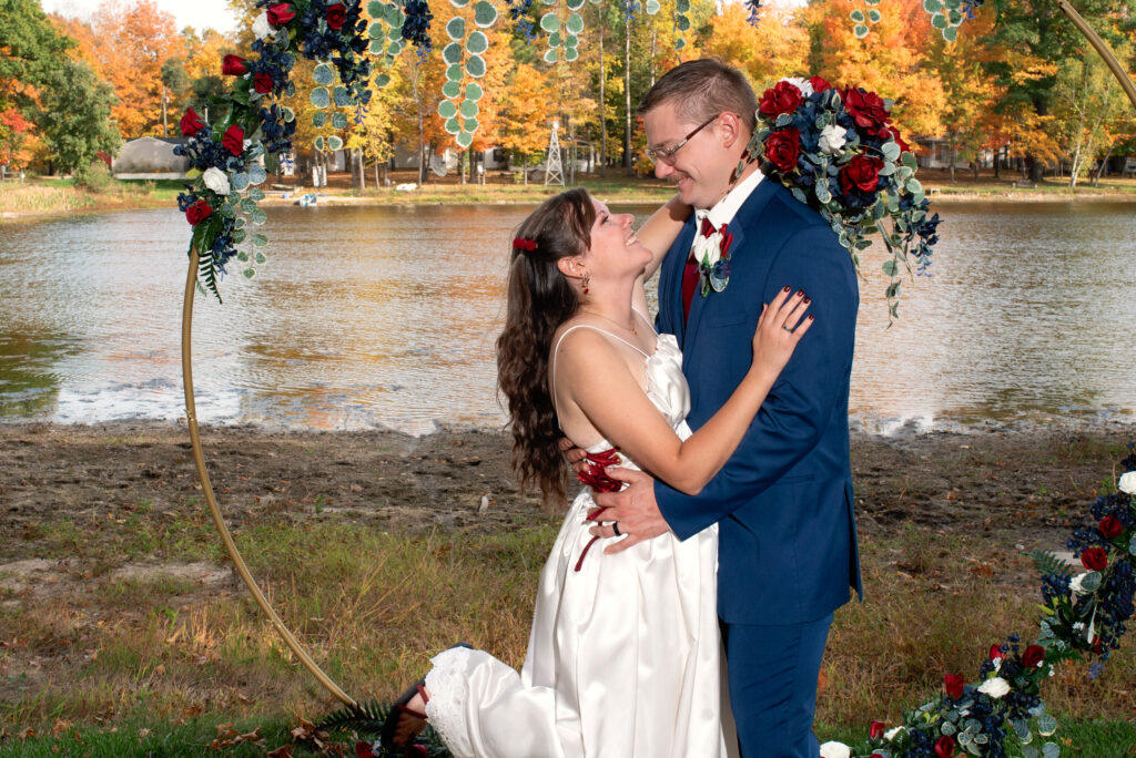 Bride and Groom with fall colors and lake in the background.